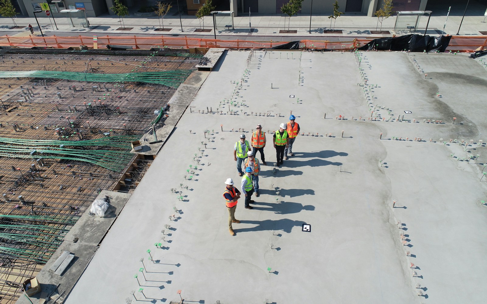 Concrete crew coordinating layout on a newly poured slab